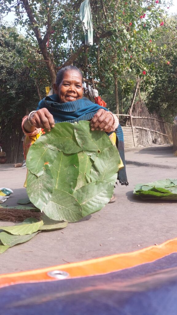 Women crafting eco-friendly bags and utensils using natural resources in a rural setting